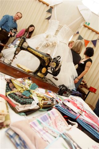 Picture of a sewing machine and fabrics taken at the 2011 Clothes Swop