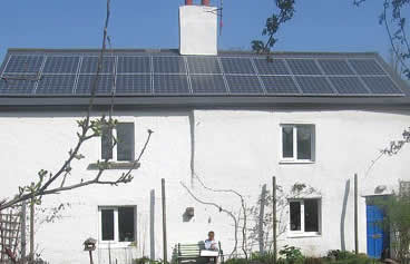 Photograph of photovoltaic panels on the roof of a cottage