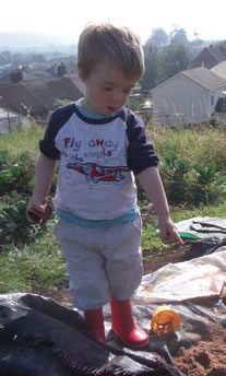 Photograph of a child in an allotment