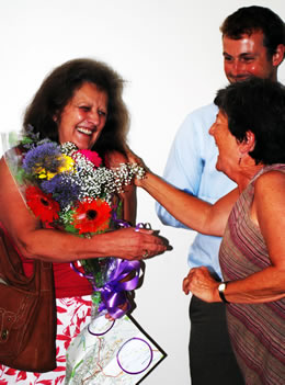Photograph of Sarah Green being presented with a bouquet of flowers by Laura Conyngham