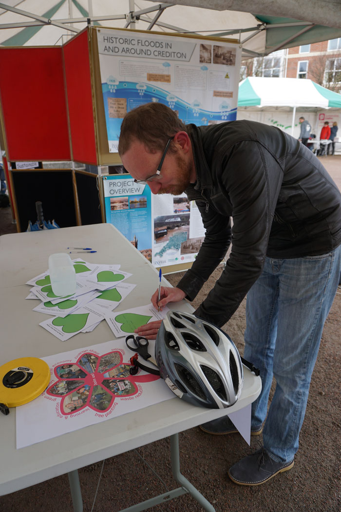 Photograph of someone writing their 'green heart' commitment