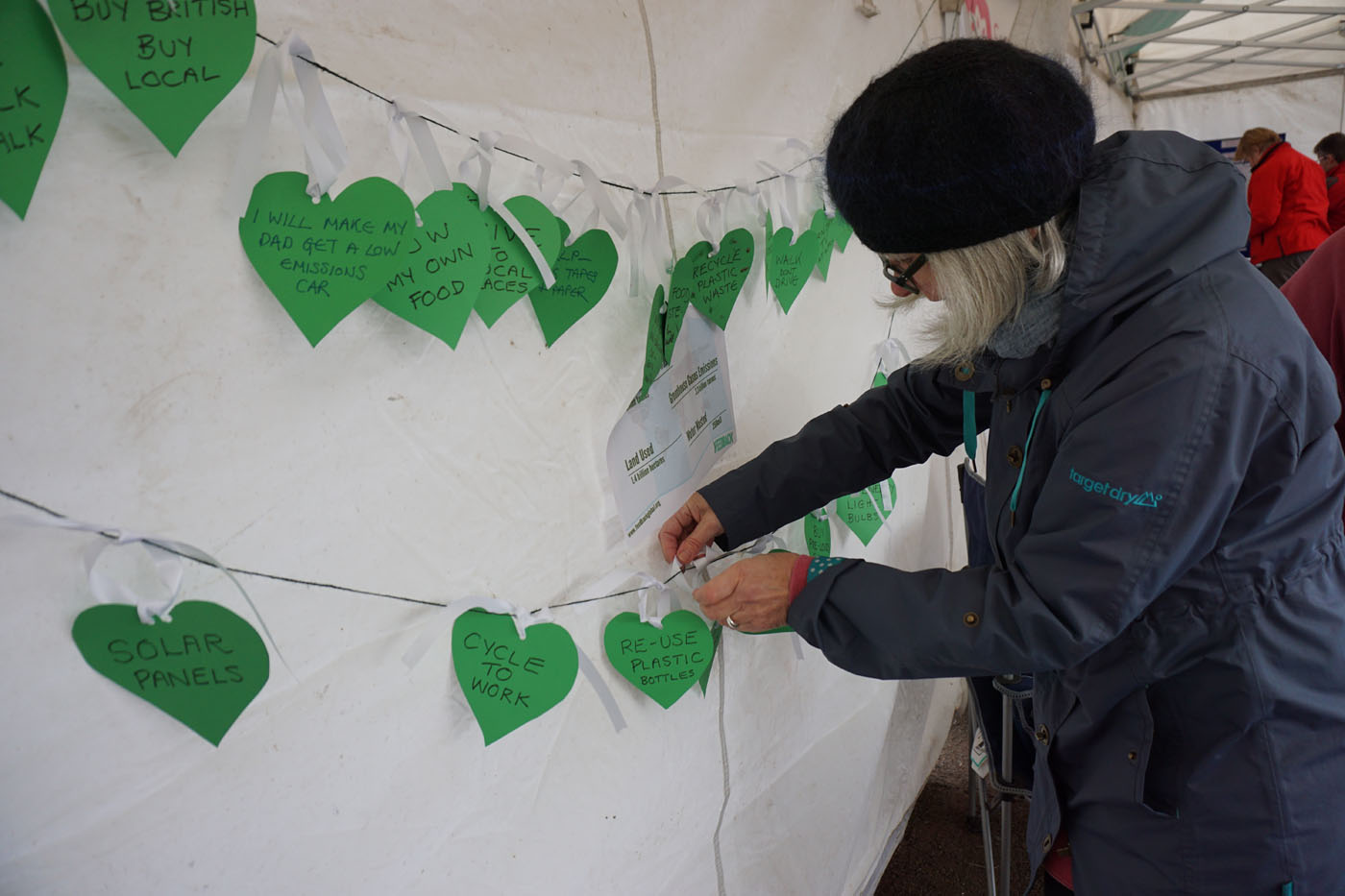 Photograph of a string of pledges written on green hearts